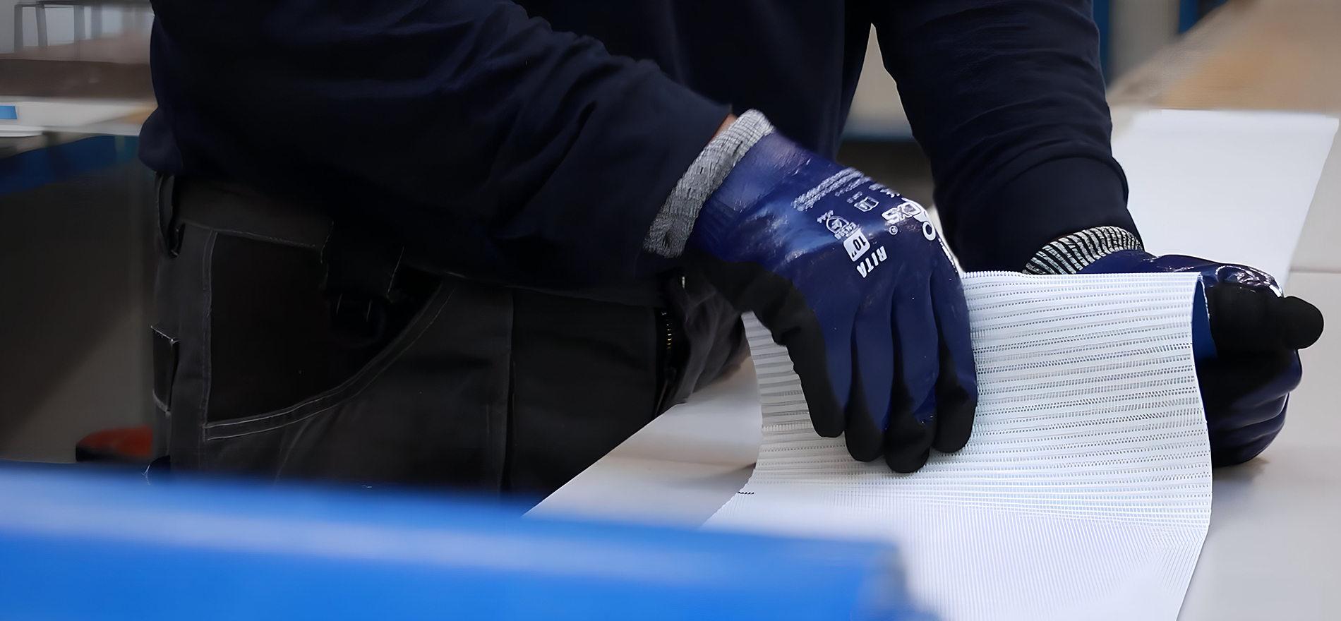 Industrial conveyor belt material being inspected by MIR technician
